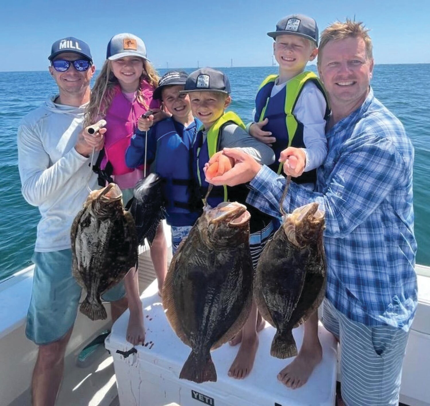 BEST TEAM PHOTO: Best Team Photo in Block Island Tournament was awarded to team ‘Defiant’ for this photo taken in the Block Island Wind Farm with some nice fluke caught by young anglers.